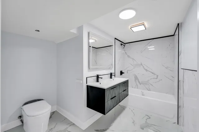 a bathroom with a tub sink toilet and a mirror