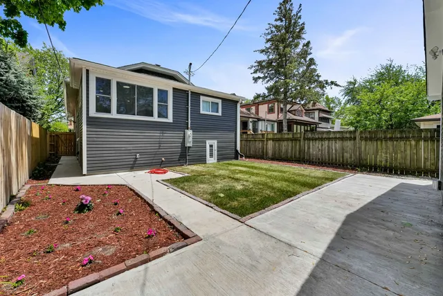 a view of a backyard with a wooden fence