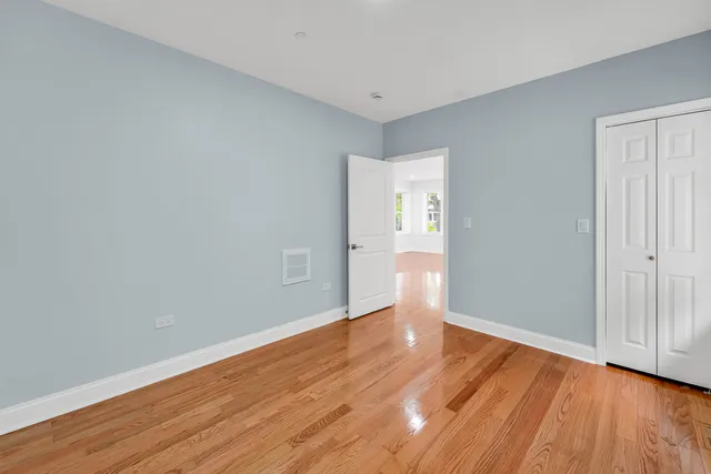 a view of wooden floor and windows in a room
