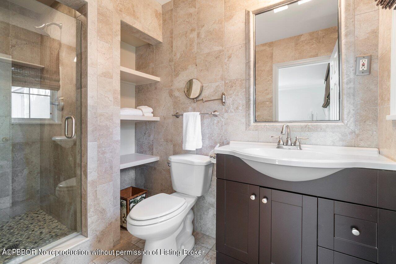 257 Fairview Road Palm Beach, FL 33480 - Photo 13 of 20 a bathroom with a sink toilet and shower