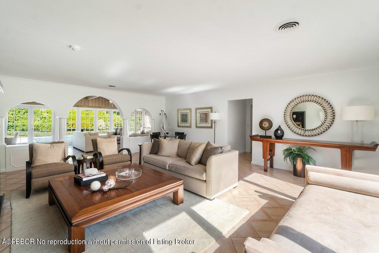 257 Fairview Road Palm Beach, FL 33480 - Photo 4 of 20 a living room with furniture a window and a clock