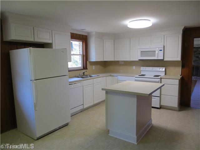 1859 Underpass Road Advance, NC 27006 - Photo 5 of 16 Kitchen. Island, new appliances, tile floor and fresh tile backsplash and new cabinets make this a kitchen everyone can enjoy.