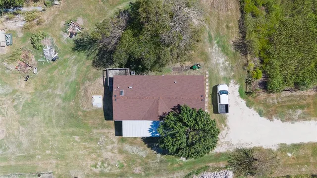 an aerial view of a house with outdoor space