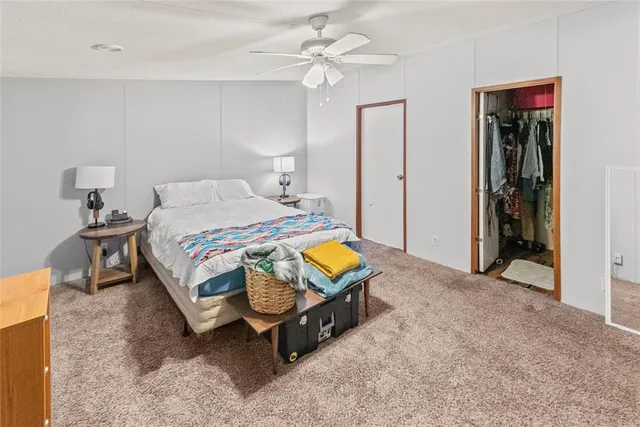 a bathroom with a granite countertop sink a mirror and a shower