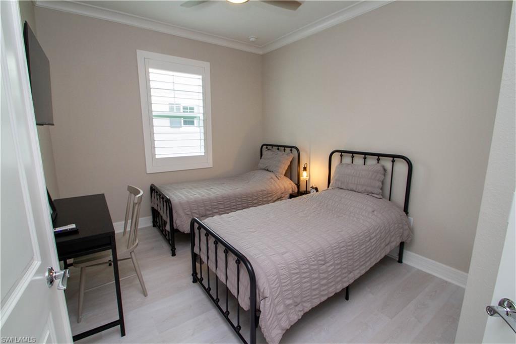 251 Indies Drive East, Unit 202 Naples, FL 34114 - Photo 26 of 48 a bedroom with bed and a window