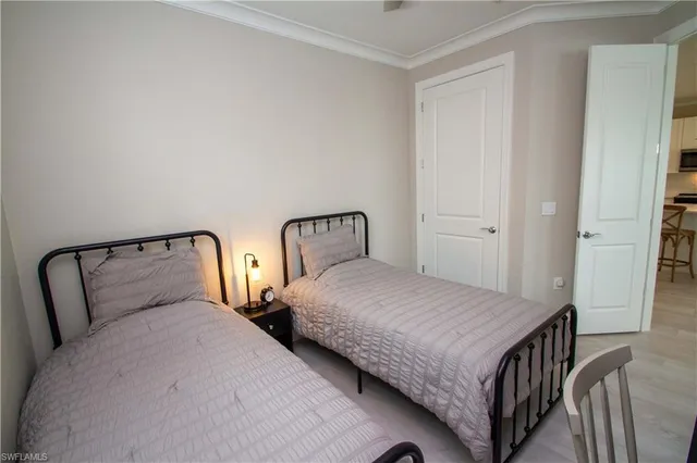 a bedroom with a bed and a night stand