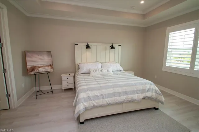 a bedroom with a bed a couch and dresser