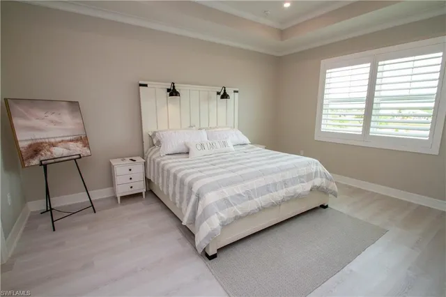 a bedroom with a bed and a tv on the dresser
