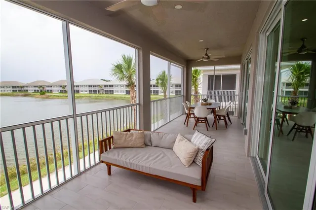 a living room with furniture and a floor to ceiling window