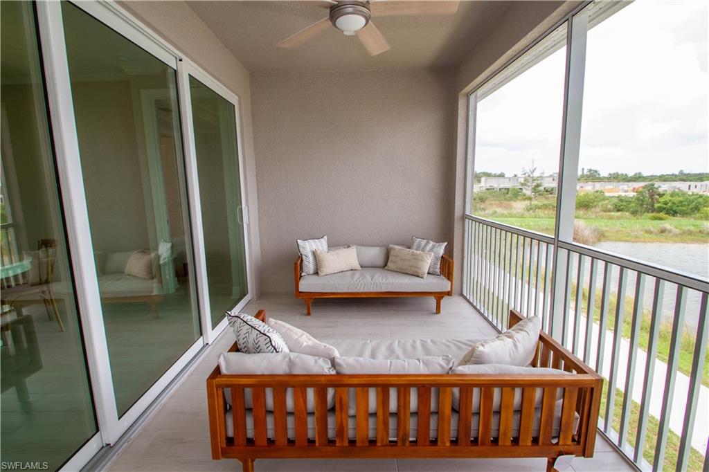 251 Indies Drive East, Unit 202 Naples, FL 34114 - Photo 39 of 48 a bedroom with bed couch and window