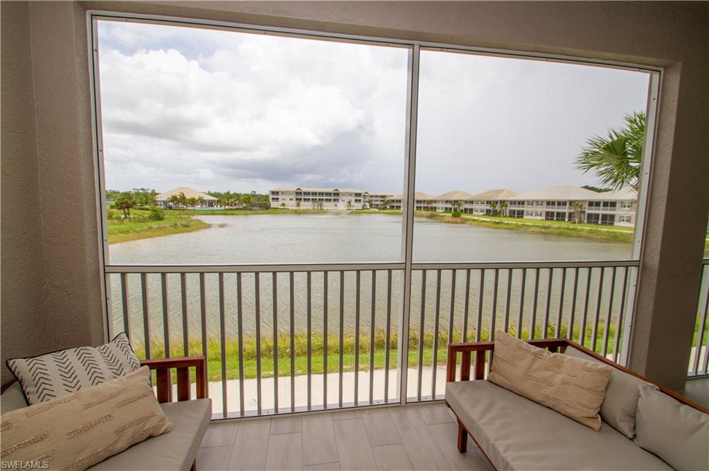 251 Indies Drive East, Unit 202 Naples, FL 34114 - Photo 40 of 48 a balcony with view of city with furniture