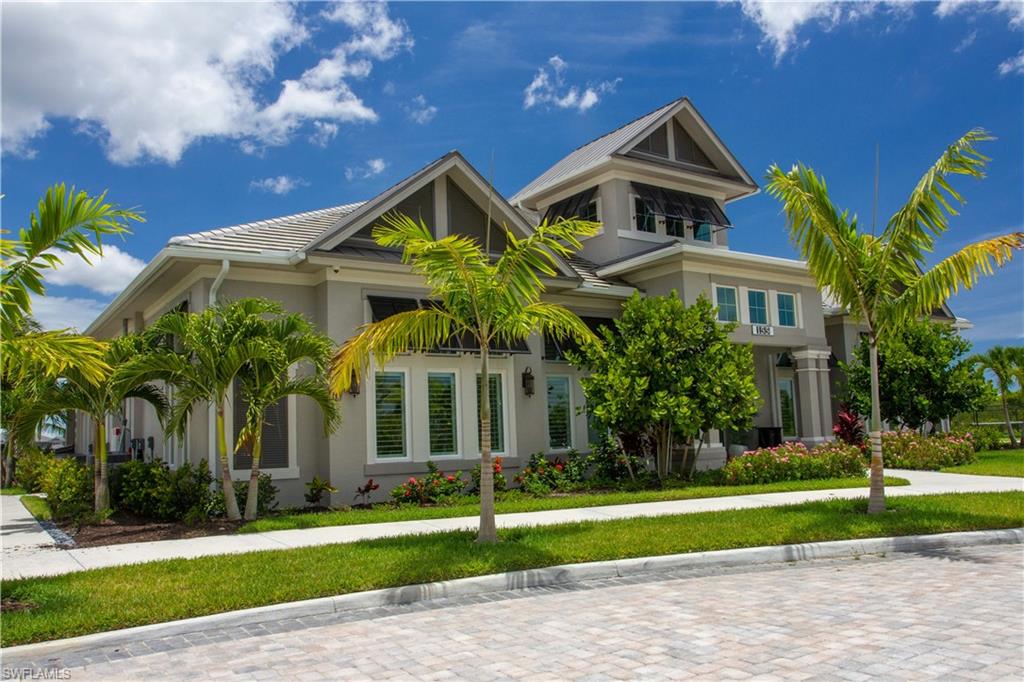 251 Indies Drive East, Unit 202 Naples, FL 34114 - Photo 41 of 48 a front view of a house with a yard