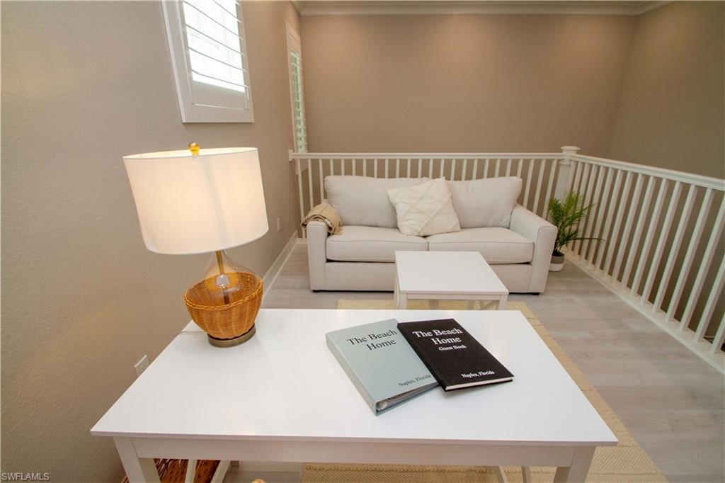 251 Indies Drive East, Unit 202 Naples, FL 34114 - Photo 7 of 48 a living room with furniture and a window