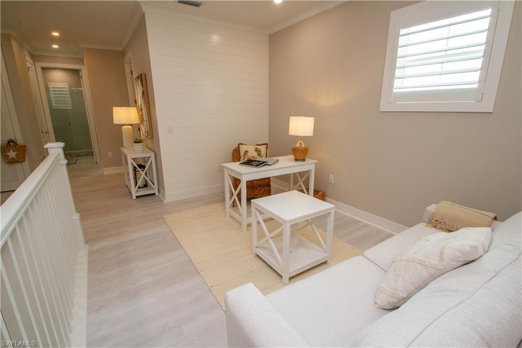 251 Indies Drive East, Unit 202 Naples, FL 34114 - Photo 8 of 48 a living room with a bed furniture and a window