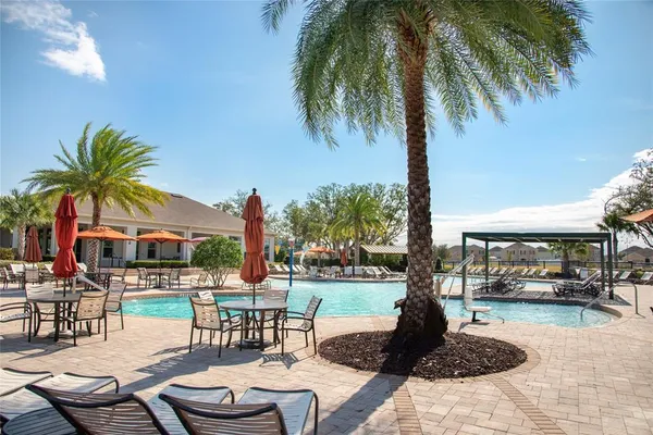 a view of a patio with swimming pool table and chairs