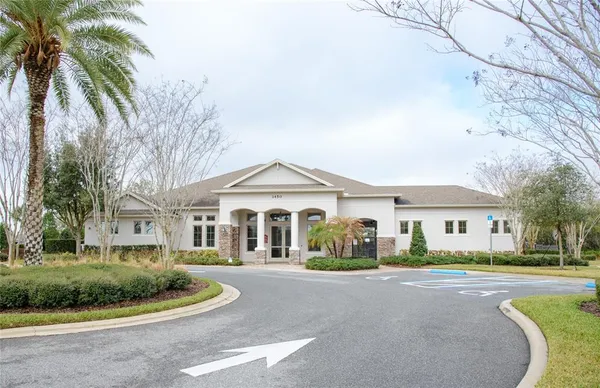 a front view of a house with a garden and plants