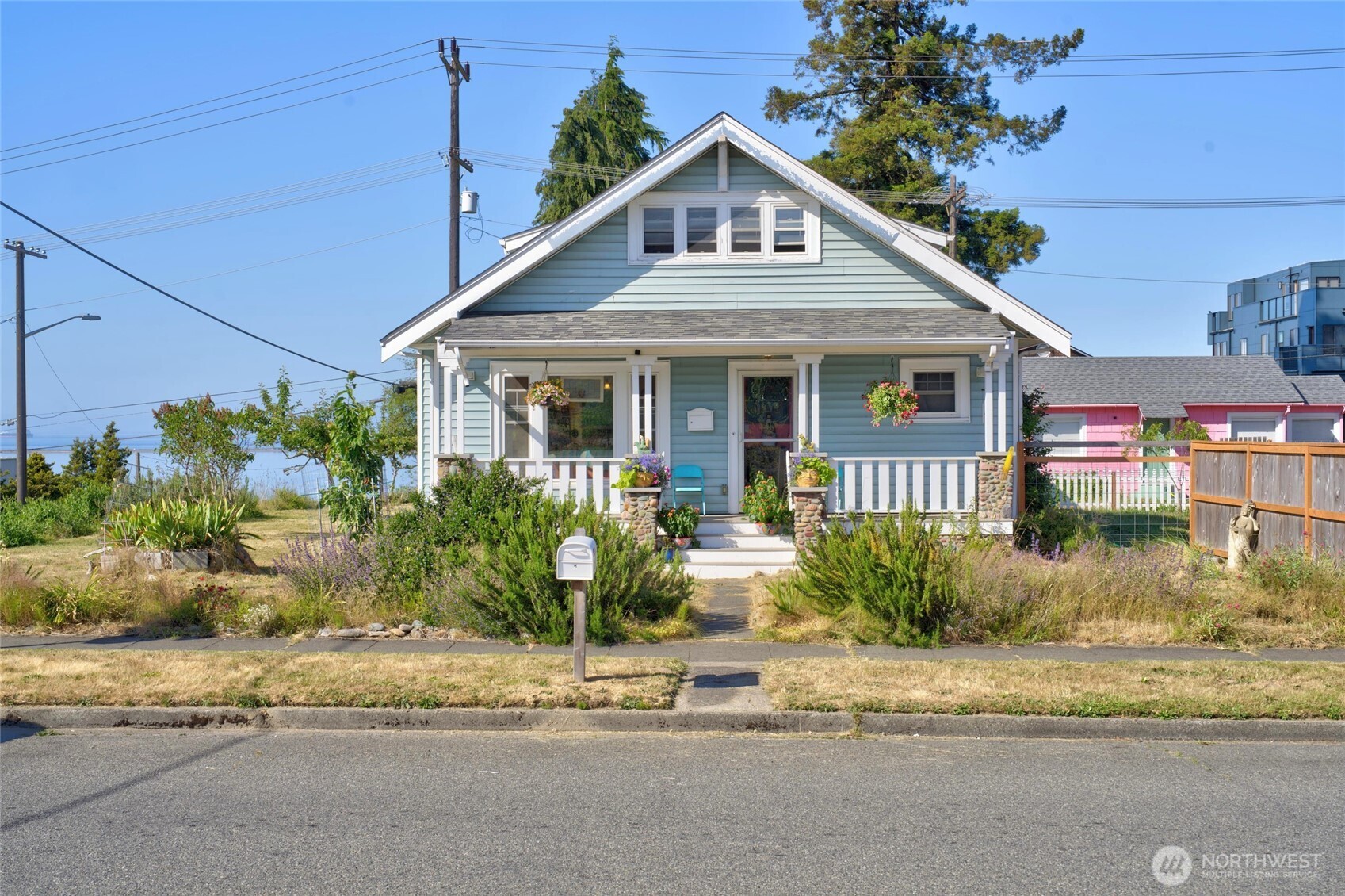 237 West 3rd Street Port Angeles, WA 98362 - Photo 37 of 40 a front view of a house with a yard and potted plants