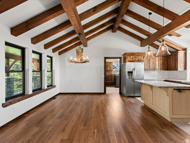 1225 Old Oregon Road Soda Springs, ID 83276 - Photo 9 of 67 Vaulted ceilings with exposed wood beams, hardwood flooring, and a kitchen island with pendant lighting