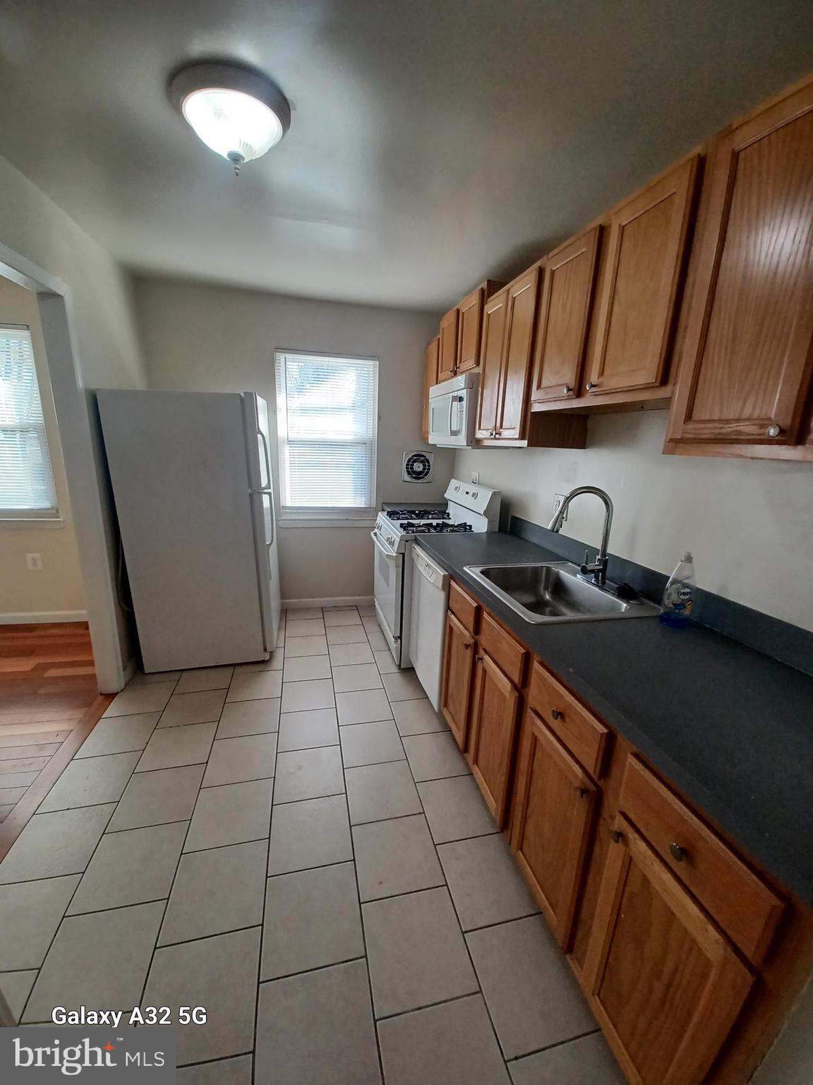 8213 Coatsbridge Court Severn, MD 21144 - Photo 8 of 19 a kitchen with stainless steel appliances granite countertop a sink stove and cabinets