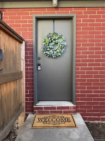 a view of a door and brick wall