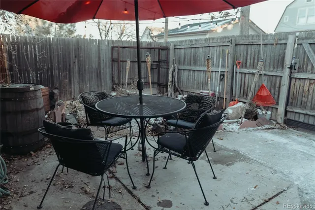 a backyard of a house with table and chairs