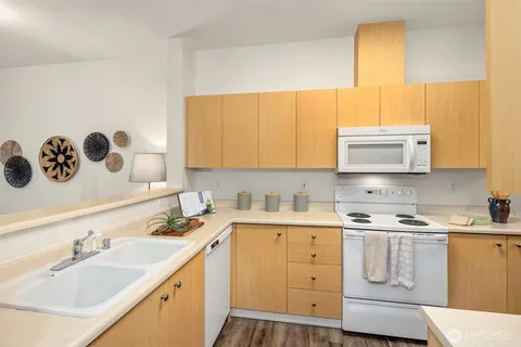 a kitchen with a sink a stove and cabinets