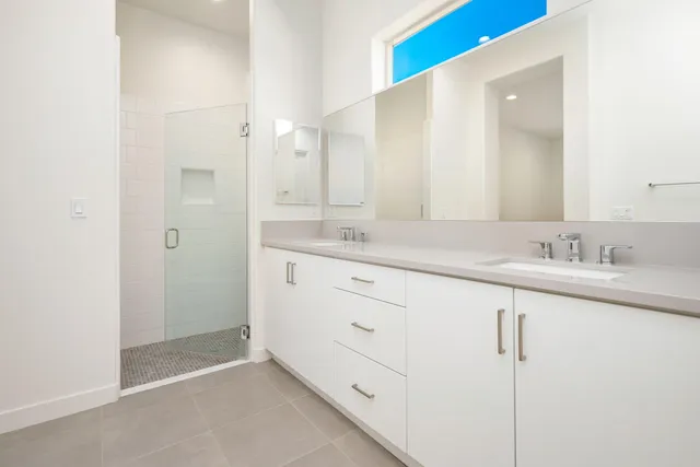 a bathroom with a sink and a mirror with toilet