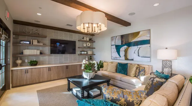 a living room with furniture a flat screen tv and a large window