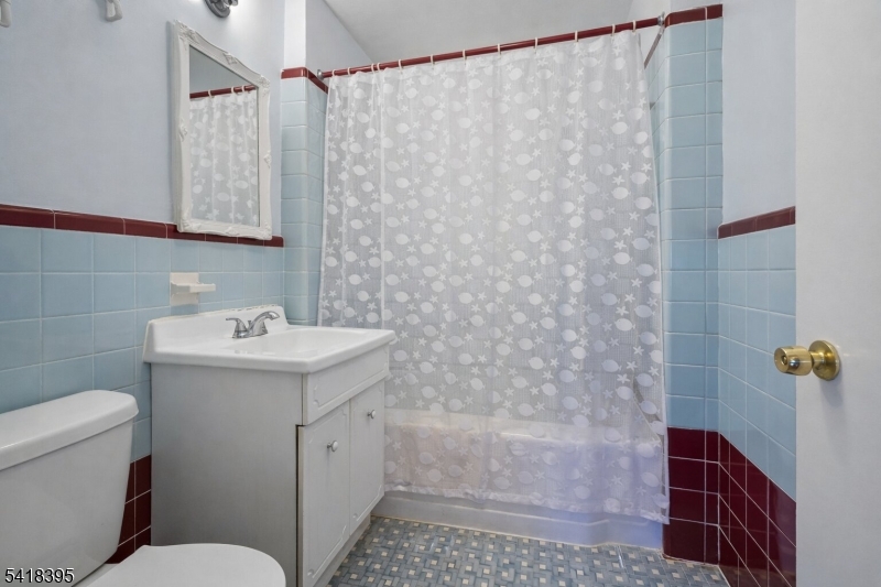 2970 Aberdeen Road Union, NJ 07083 - Photo 11 of 18 a bathroom with a sink a toilet and shower