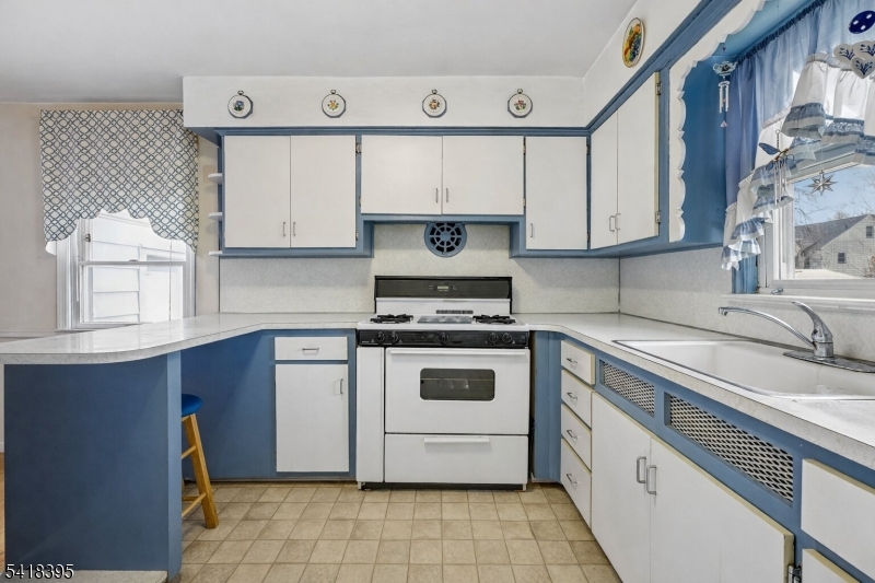 2970 Aberdeen Road Union, NJ 07083 - Photo 7 of 18 a white kitchen with granite countertop a stove a sink and a white cabinets