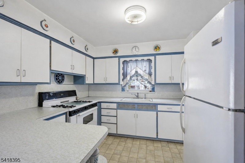 2970 Aberdeen Road Union, NJ 07083 - Photo 8 of 18 a kitchen with stainless steel appliances a sink stove and cabinets