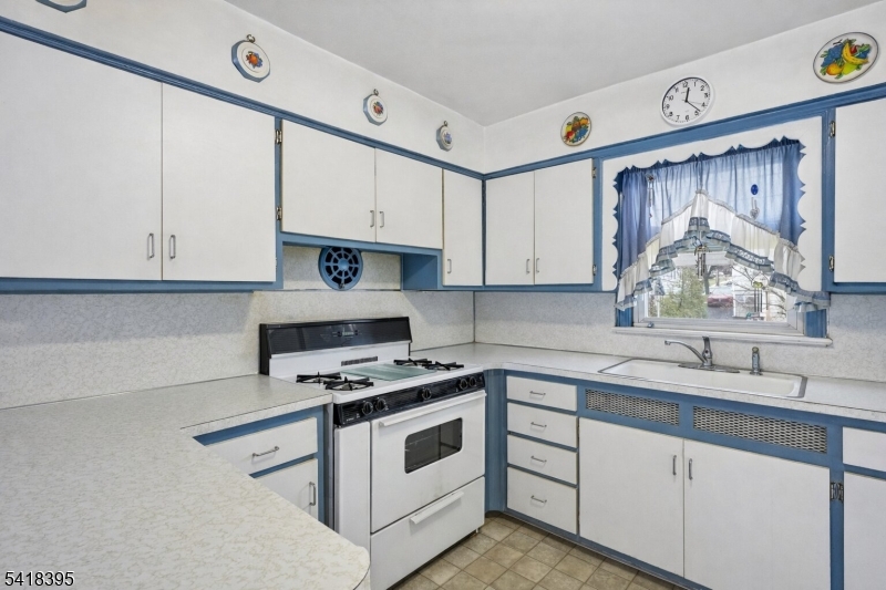 2970 Aberdeen Road Union, NJ 07083 - Photo 9 of 18 a kitchen with cabinets appliances a sink and a window
