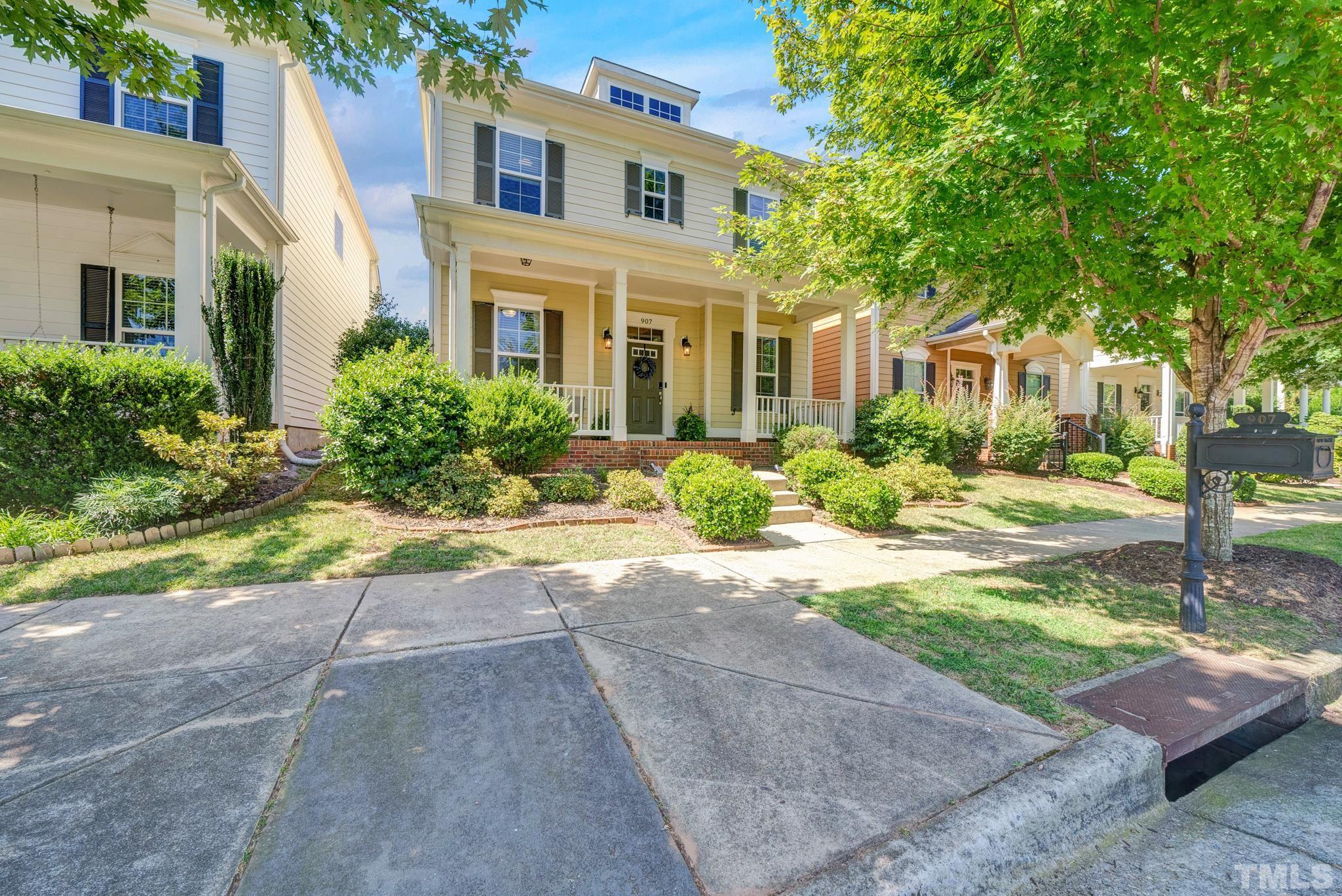 907 Chapanoke Road Raleigh, NC 27603 - Photo 1 of 26 a front view of a house with a yard and potted plants
