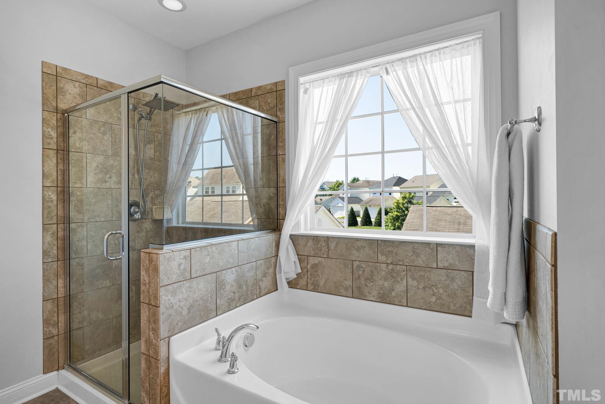 907 Chapanoke Road Raleigh, NC 27603 - Photo 14 of 26 a bathroom with a tub and shower