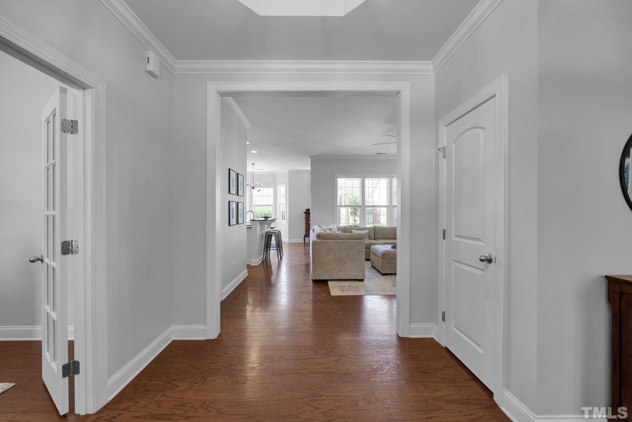 907 Chapanoke Road Raleigh, NC 27603 - Photo 4 of 26 a view of a hallway with wooden floor windows and a living room