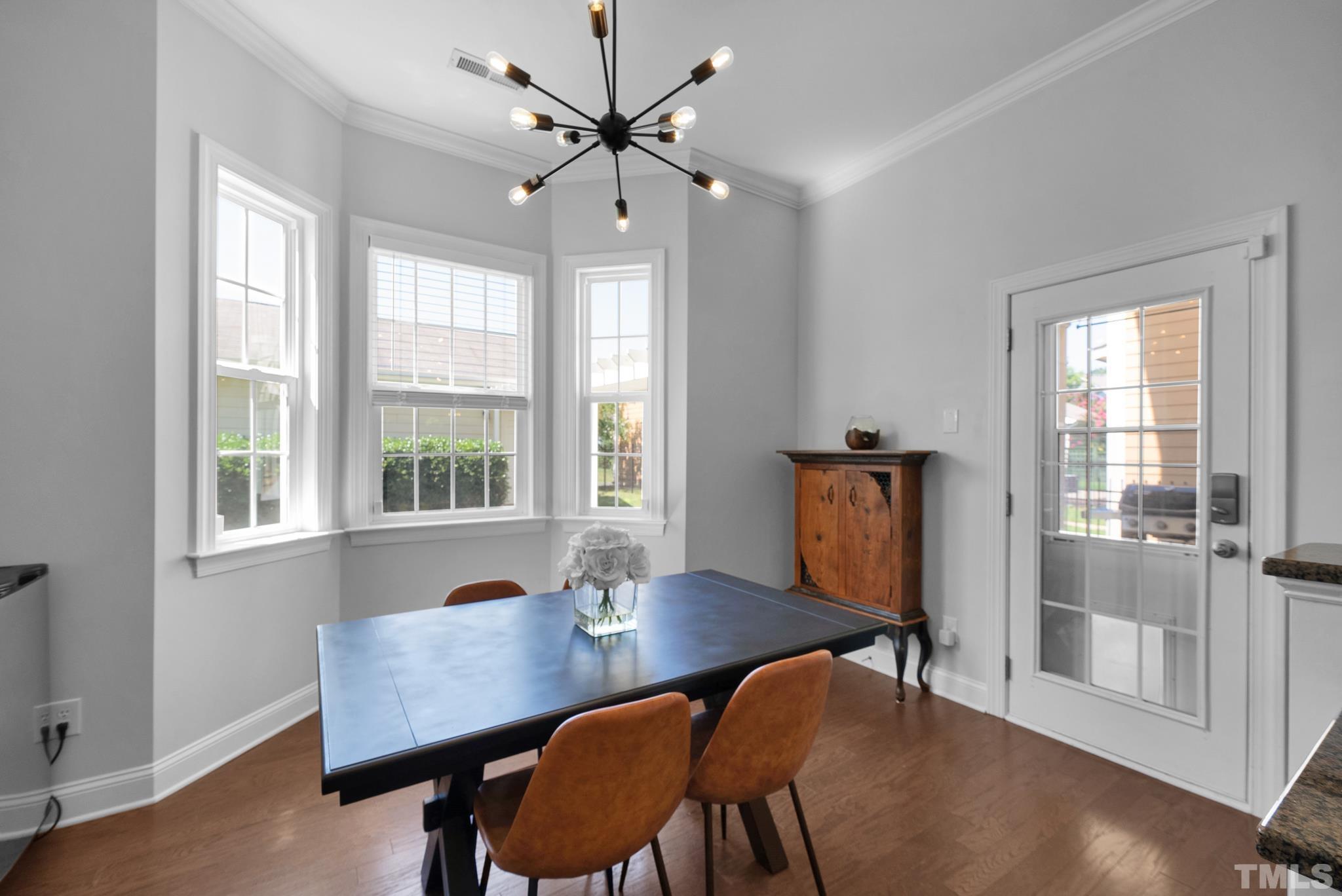907 Chapanoke Road Raleigh, NC 27603 - Photo 10 of 26 a view of a dining room with furniture window and wooden floor