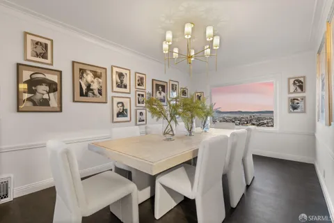 a living room with a table and a mirror
