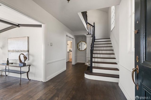 a very nice looking room with wooden floor and furniture