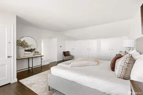 a view of a balcony with wooden floor and furniture