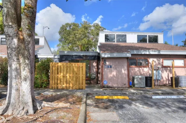 a backyard of a house with barbeque oven table and chairs
