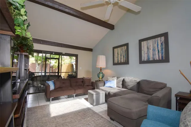a living room filled with furniture and a window