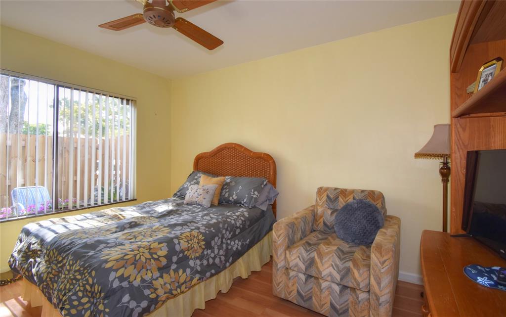 1748 Northwest 74th Avenue, Unit 19 Plantation, FL 33313 - Photo 18 of 44 a bedroom with a bed and a flat tv screen on dresser
