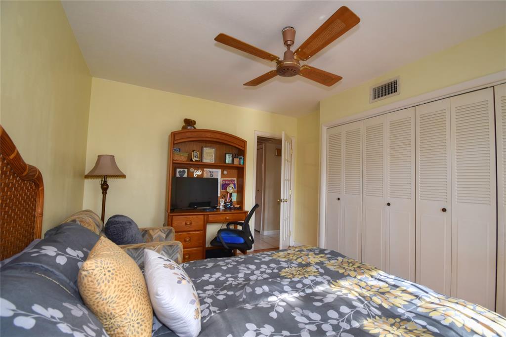 1748 Northwest 74th Avenue, Unit 19 Plantation, FL 33313 - Photo 20 of 44 a bedroom with a bed and a mirror