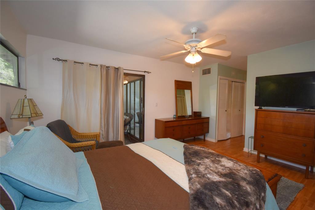 1748 Northwest 74th Avenue, Unit 19 Plantation, FL 33313 - Photo 28 of 44 a bedroom with a bed and a flat screen tv