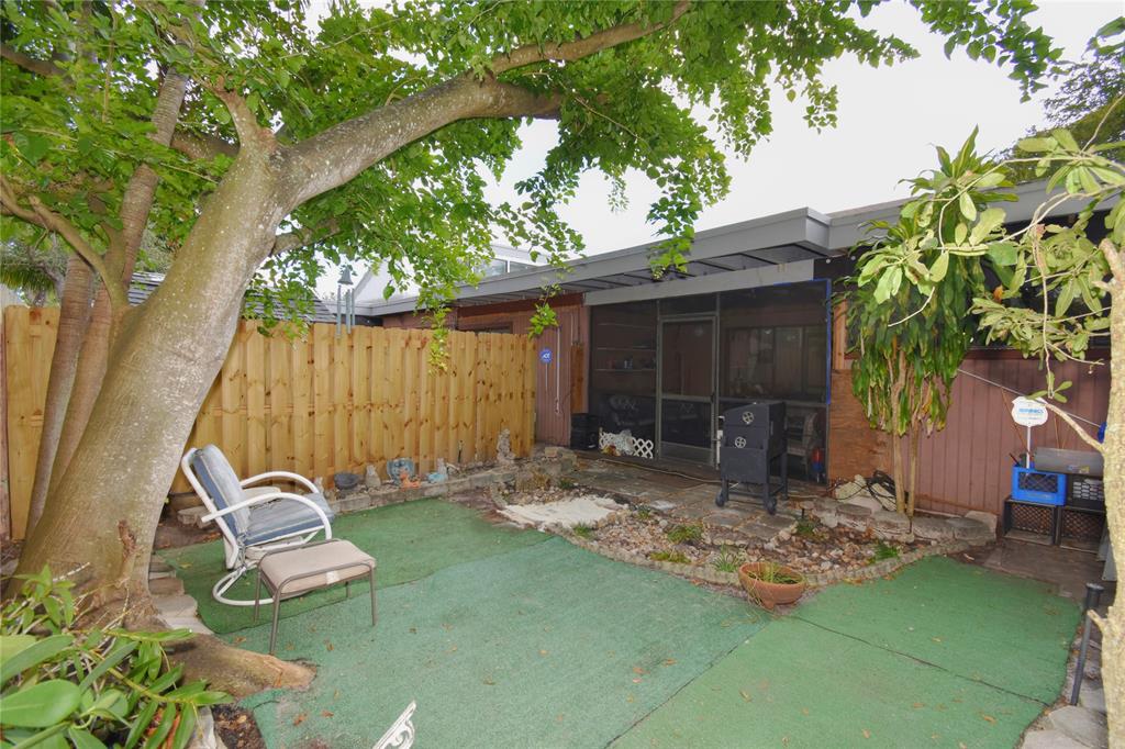 1748 Northwest 74th Avenue, Unit 19 Plantation, FL 33313 - Photo 35 of 44 a backyard of a house with seating space