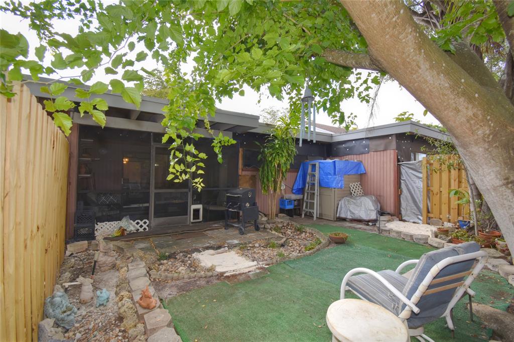 1748 Northwest 74th Avenue, Unit 19 Plantation, FL 33313 - Photo 36 of 44 a view of a house with backyard porch and sitting area
