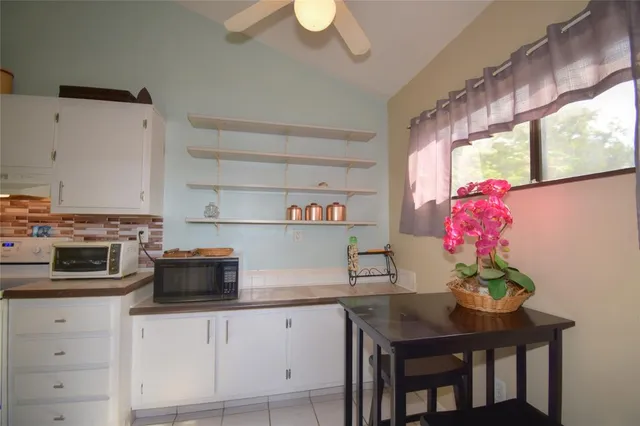a bedroom with a bed and a flat tv screen on dresser