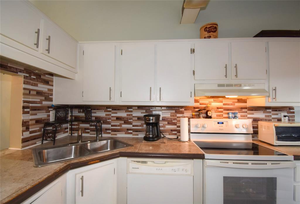 1748 Northwest 74th Avenue, Unit 19 Plantation, FL 33313 - Photo 9 of 44 a kitchen with granite countertop a sink and cabinets
