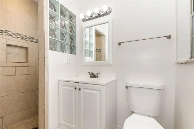 a bathroom with a toilet sink and mirror