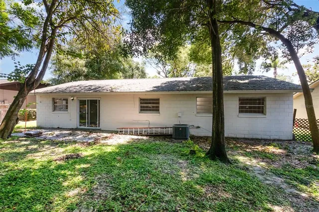 a view of a house with a yard and tree